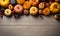 Pumpkin autumn decor flatlay on wooden table.Autumn composition. Pumpkins,fallen leaves on wooden table. Happy