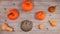 Pumpkin autumn halloween scenery on a wooden desk. Top view, tabletop with different kinds of pumpkins, spiders crawling