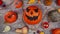 Pumpkin autumn halloween scenery on a wooden desk. Top view, tabletop stop motion animation with jack o lantern and spiders