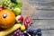 Pumpkin with autumn vegetables and fruits on vintage boards