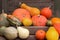 Pumpkin background. Many ripe pumpkins of different shapes, orange autumn vegetables. Harvest concept