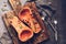 Pumpkin baked or butternut squash pumpkin with thyme on a cutting board, dark rustic background. Top view, flat lay. The concept