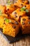 Pumpkin bars with pieces of chocolate and mint close-up on a slate board. vertical