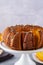 Pumpkin cake with honey on a gray background. Copy space