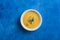 Pumpkin and carrot soup with cream and spinach with crackers on a classic blue background