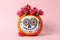 Pumpkin with catrina skull makeup and flowers on pink background