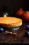 Pumpkin cheesecake, cooked at home, pumpkin, plum, vanilla , foliage on a wooden dark table.
