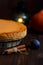 Pumpkin cheesecake, cooked at home, pumpkin, plum, vanilla on a wooden dark table.