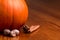 Pumpkin, cinnamon sticks, and nutmeg on a wooden table