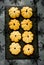 Pumpkin cookies on black slate plate for Halloween party