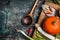 Pumpkin cooking on rustic kitchen table background with ingredients and wooden cooking spoon, top view