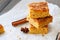 Pumpkin cornmeal bars with spices on a wooden background. Close