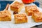 Pumpkin cornmeal bars with spices on a wooden background. Close