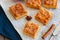 Pumpkin cornmeal bars with spices on a wooden background. Close