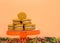 Pumpkin cream cookies on a pedestal with confetti below orange background