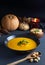 Pumpkin cream served on a black plate, rustic atmosphere