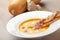 Pumpkin cream soup purÃ©e with bread slice, bacon and seeds