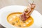 Pumpkin cream soup purÃ©e with bread slice, bacon and seeds