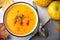 Pumpkin cream soup with rosemary and paprika in blue bowl. Halloween Thanksgiving Autumn food concept