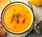 Pumpkin cream soup with rosemary and paprika in blue bowl. Halloween Thanksgiving Autumn food concept