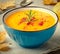 Pumpkin cream soup with rosemary and paprika in blue bowl. Halloween Thanksgiving Autumn food concept