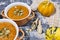 pumpkin cream soup with seeds, sesame and rucola on a grey background. Autumn flat lay. Top view. Cozy photo.