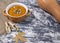 Pumpkin cream soup with seeds, sesame and rucola on a grey background. Autumn flat lay. Top view. Cozy photo