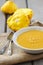 Pumpkin creamy soup in ceramic plate on wooden table