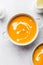 Pumpkin creamy soup decorated with fresh cream