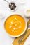 Pumpkin creamy soup decorated with fresh cream