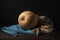 Pumpkin and ears of wheat on blue tissue on wooden table.