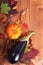 Pumpkin, Eggplant and nuts on Autumn leaves on wood background for seasonal or halloween holidays background