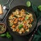 Pumpkin farfalle pasta with pumpkin seeds and cheese in bowl