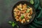 Pumpkin farfalle pasta with pumpkin seeds and cheese in bowl