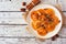 Pumpkin filled ravioli pasta above view on a rustic white wood background