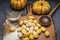 Pumpkin gnocchi Ingredients for cooking strainer spoon flour on Ñutting board on dark rustic background close up