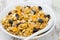 Pumpkin granola with dried fruit and seeds in a bowl closeup