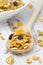 Pumpkin granola with dried fruit and seeds in a spoon closeup