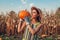 Pumpkin harvest. Young woman farmer picking autumn crop of pumpkins on farm. Agriculture. Thanksgiving and Halloween