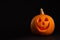 Pumpkin head on black background. Jack lantern - traditional Halloween decor