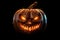 A pumpkin head with scary smile on a black background. Jack-o-lantern with illuminated Halloween background