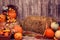 Pumpkin heads and autumn props on wooden background