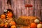 Pumpkin heads and autumn props on wooden background