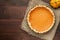 Pumpkin homemade pie at wooden background arranged with food ing