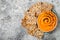 Pumpkin hummus seasoned with olive oil and black sesame seeds with whole grain crackers. Healthy vegetarian appetizer or snack.