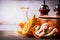 Pumpkin on kitchen desk table with cooking pot, oil and ginger. Food background for Autumn cooking inspiration