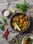 Pumpkin lentil curry and rice on a wooden table, top view. Indian vegetarian food