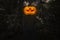 Pumpkin monster head on man body standing over dark forest and t