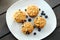 Pumpkin muffins with cranberries on wooden background