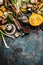 Pumpkin and Other autumn vegetables and seasoning ingredients for seasonal cooking on rustic kitchen table background